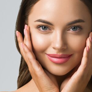 Beauty woman skin care beautiful female hand touching face cosmetic girl model over blue background