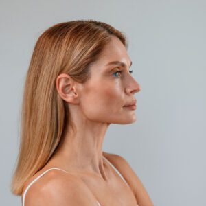 Portrait of woman that is standing against background.