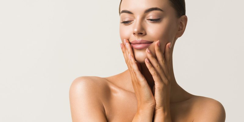 Healthy skin woman natural makeup beauty face closeup with hands